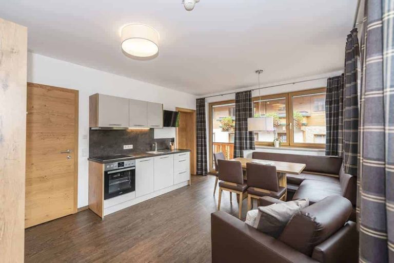 Modern Apartment with Kitchen, Dining Area, and Balcony at Pension Niederreiter Maria Alm