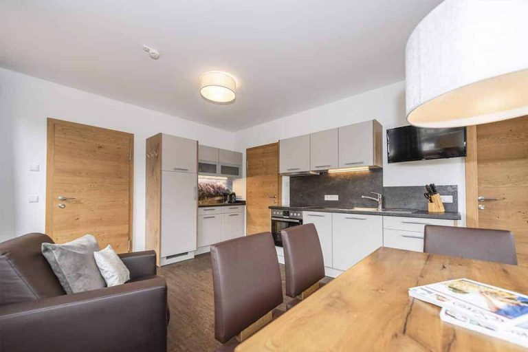 Modern Holiday Apartment at Pension Niederreiter Maria Alm with Kitchen, Dining Table, and Sofa