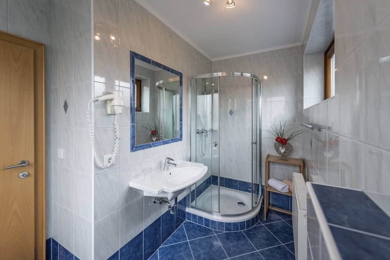 Modern Bathroom at Pension Niederreiter Maria Alm with Shower, Towel Rack, and Mirror