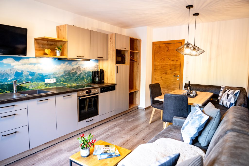 Cozy Room with Double Bed, Wooden Furniture, and Balcony View of the Mountains in Maria Alm