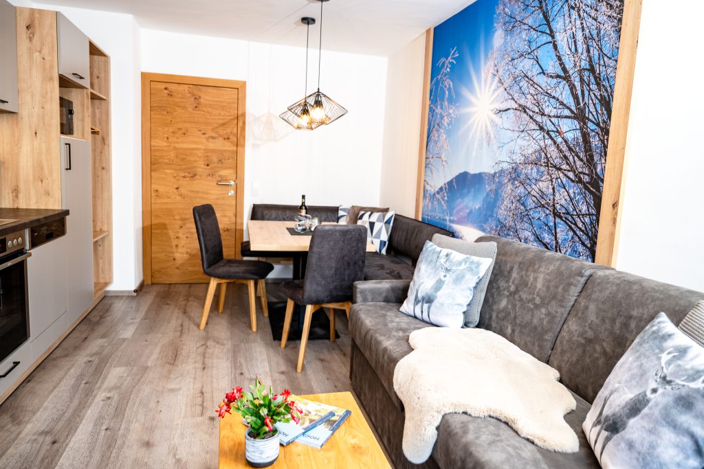 Cozy Room with Double Bed, Wooden Furniture, and Balcony View of the Mountains in Maria Alm