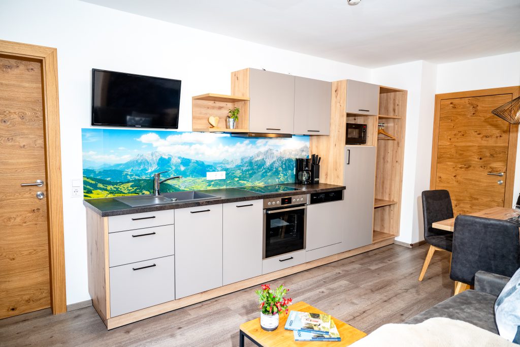 Cozy Room with Double Bed, Wooden Furniture, and Balcony View of the Mountains in Maria Alm