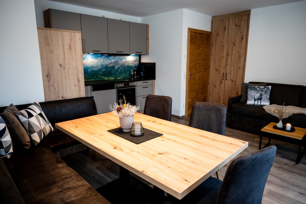 Cozy Room with Double Bed, Wooden Furniture, and Balcony View of the Mountains in Maria Alm