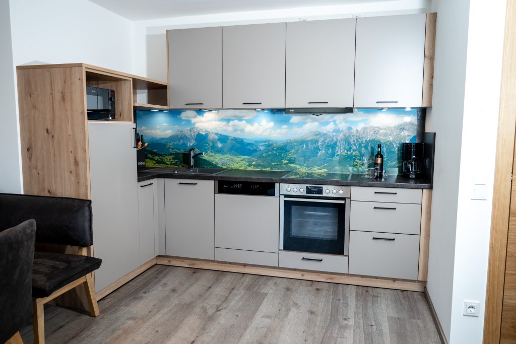 Cozy Room with Double Bed, Wooden Furniture, and Balcony View of the Mountains in Maria Alm